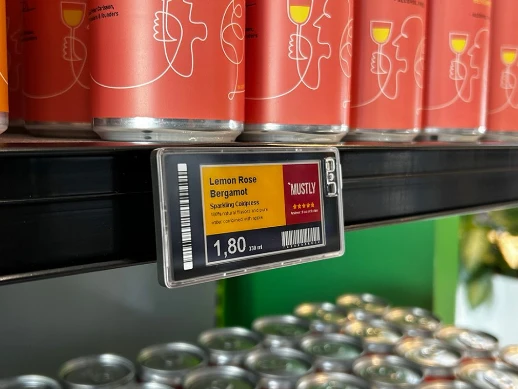 E-ink digital price tags on supermarket shelf displaying real-time pricing E-ink electronic shelf labels showing real-time digital pricing on retail store shelves